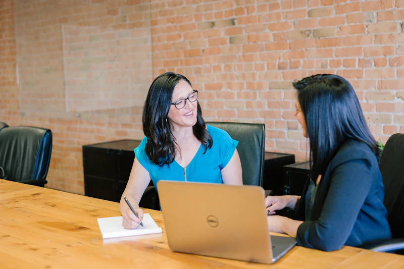 Advisor reviewing documents with a client at a desk